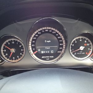 200mph Speedo. 
There's an AMG display mode in the centre of the speedo showing numeric mph, water temp and oil temp. The oil temp flashes until the